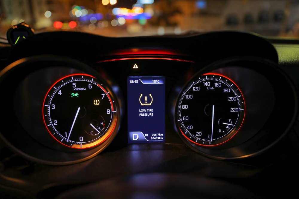 Dashboard featuring a speedometer and clock, illustrating vehicle safety standards in Florida.
