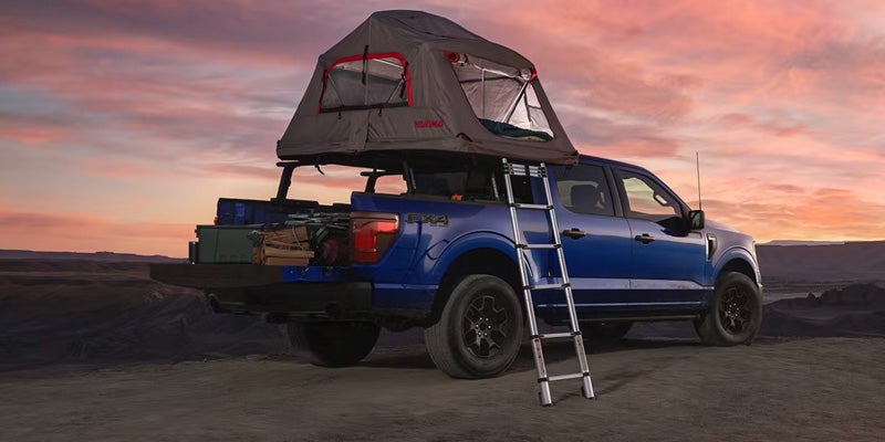 2026 Ford F-150 equipped with a rooftop camping tent and access ladder, featured in Sunrise, FL